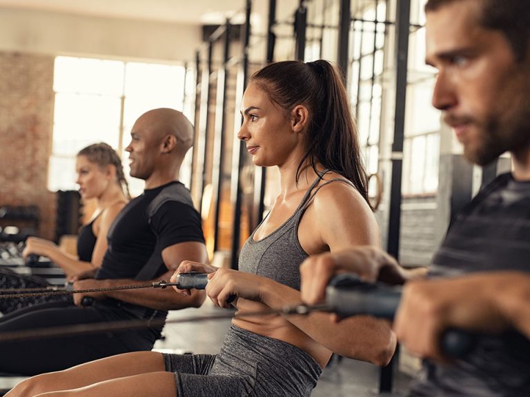 group of fitness people rowing