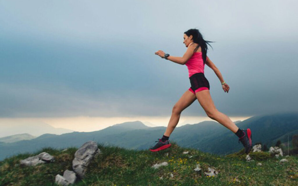 dina alborano explores the science behind high-altitude simulation for elite athletes Female endurance athlete running at high altitude on a mountain trail.